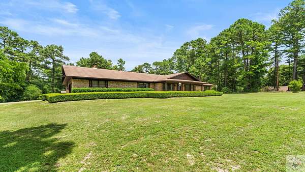 10 Acres of Residential Land with Home for Sale in Atlanta, Texas