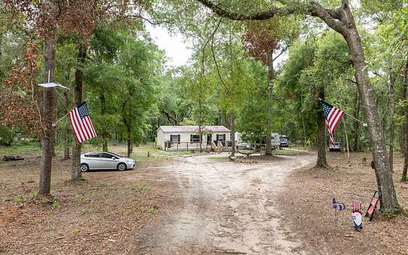5.61 Acres of Residential Land with Home for Sale in Live Oak, Florida