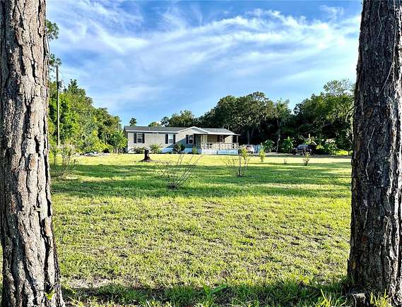 2.2 Acres of Residential Land with Home for Sale in Spring Hill, Florida