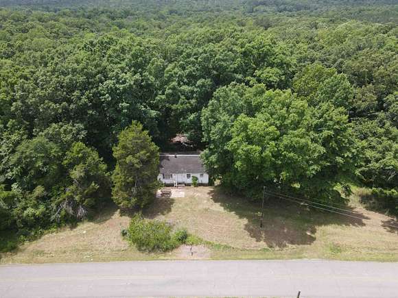 13.73 Acres of Land with Home for Sale in Scotts Hill, Tennessee