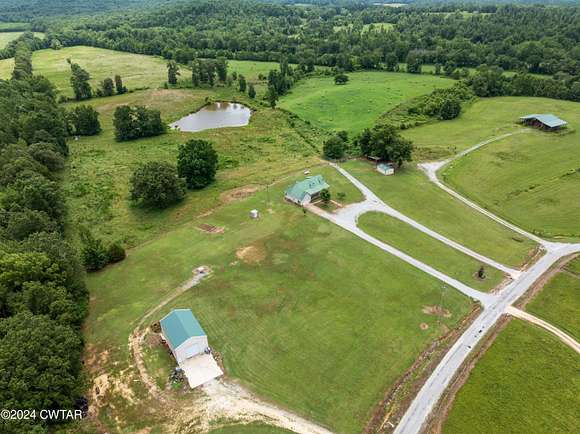 116.09 Acres of Agricultural Land with Home for Sale in Scotts Hill, Tennessee