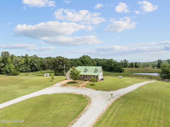 116.09 Acres of Agricultural Land with Home for Sale in Scotts Hill, Tennessee