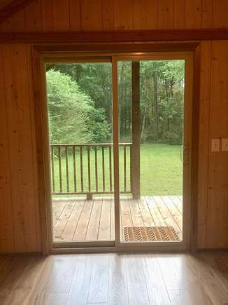 Sliding glass doors to covered porch looking out on yard