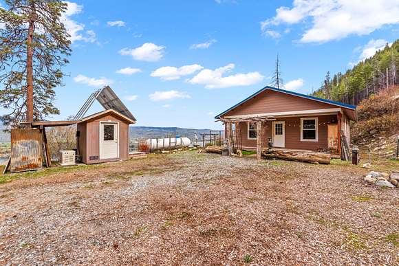 Solar shed on left with backup generator - propane tank between house and shed