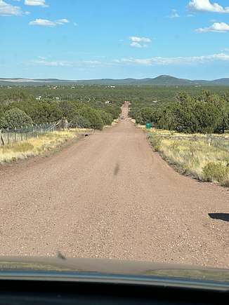 Facing East on the road, standing in front of the lot, White Mountains in the distance