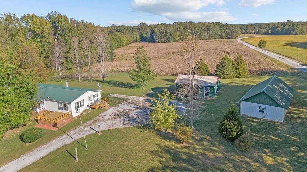 13.46 Acres of Land with Home for Sale in Big Sandy, Tennessee