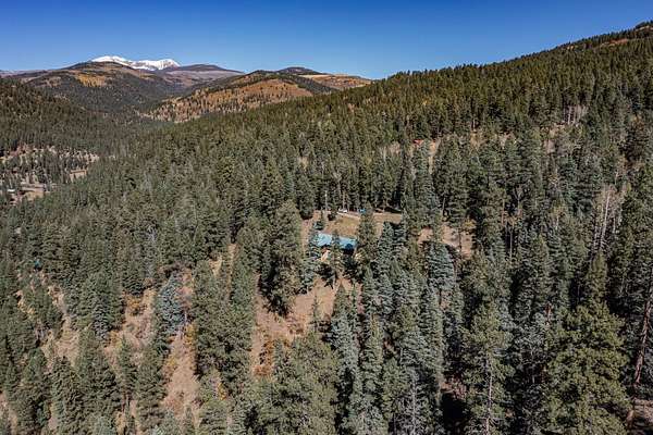 4.5 Acres of Residential Land with Home for Sale in Tererro, New Mexico