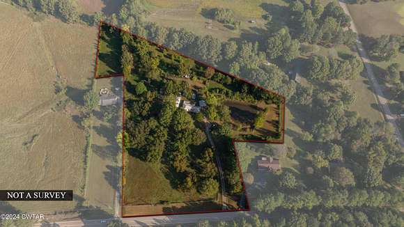 9.9 Acres of Residential Land with Home for Auction in Milan, Tennessee