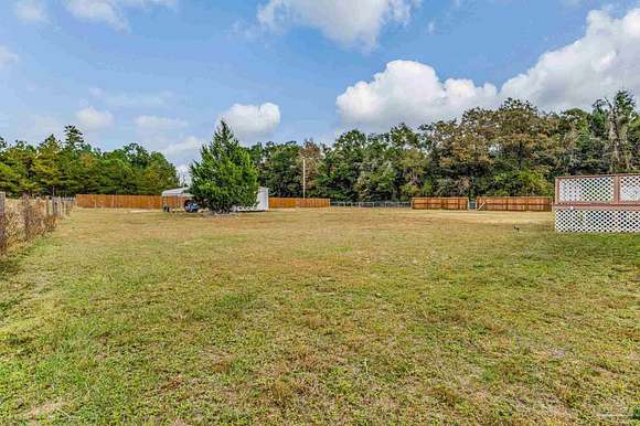 5.11 Acres of Residential Land with Home for Sale in McDavid, Florida