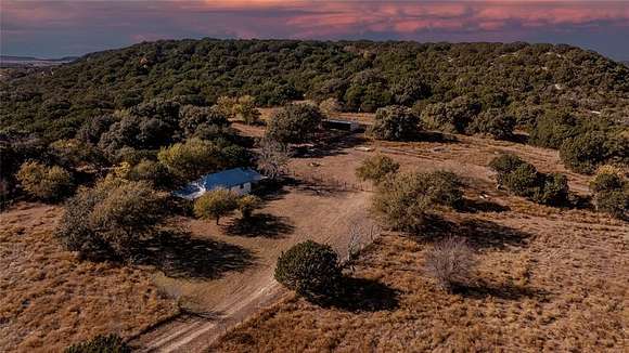 130.5 Acres of Agricultural Land with Home for Sale in Meridian, Texas