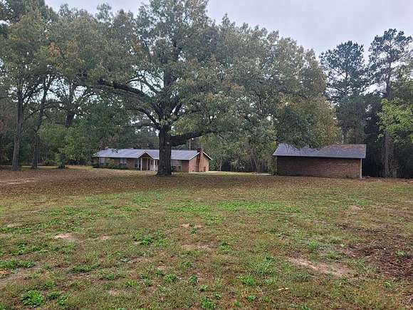 10.011 Acres of Land with Home for Sale in Elkhart, Texas