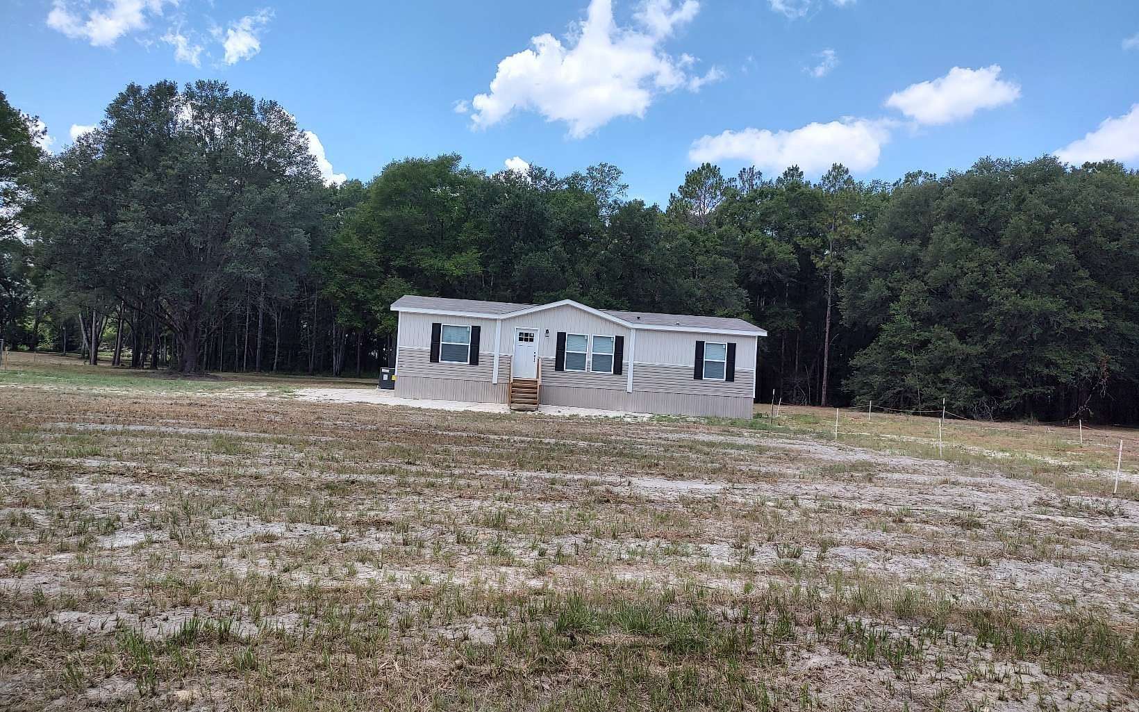 5 Acres of Residential Land with Home for Sale in McAlpin, Florida