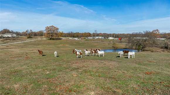 20.05 Acres of Agricultural Land with Home for Sale in Gravette, Arkansas