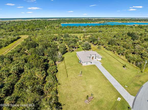 2.86 Acres of Residential Land with Home for Sale in Palm Bay, Florida