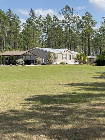 75.3 Acres of Agricultural Land with Home for Sale in Chiefland, Florida