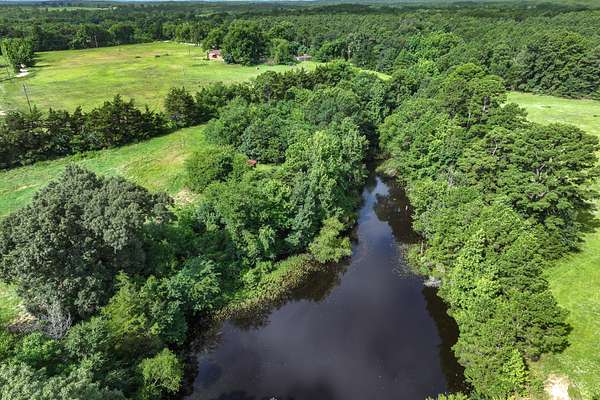 114 Acres of Land with Home for Sale in Scroggins, Texas