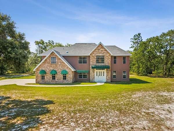 2.35 Acres of Residential Land with Home for Sale in Spring Hill, Florida