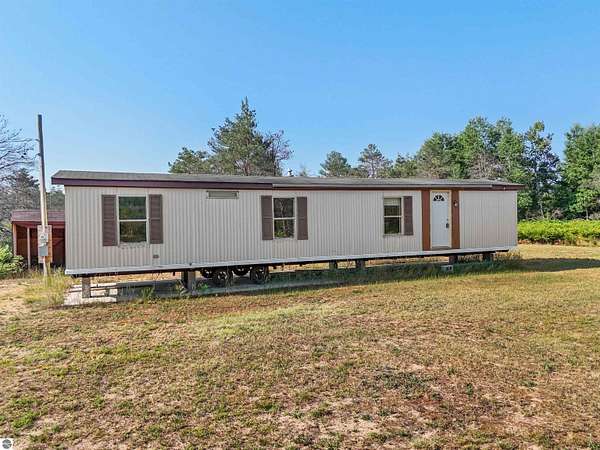 5 Acres of Residential Land with Home for Sale in Manton, Michigan