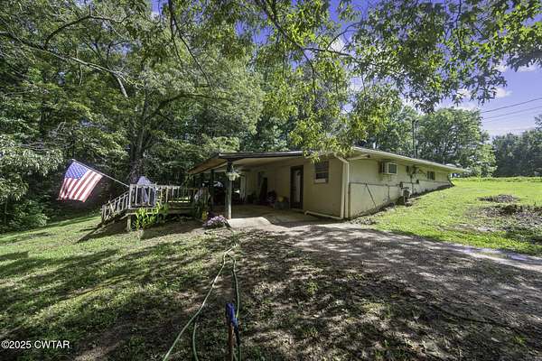 1.77 Acres of Residential Land with Home for Sale in Darden, Tennessee