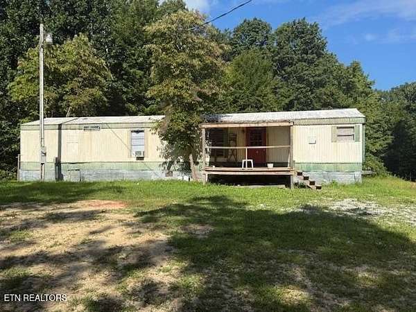 6.6 Acres of Residential Land with Home for Sale in Sunbright, Tennessee