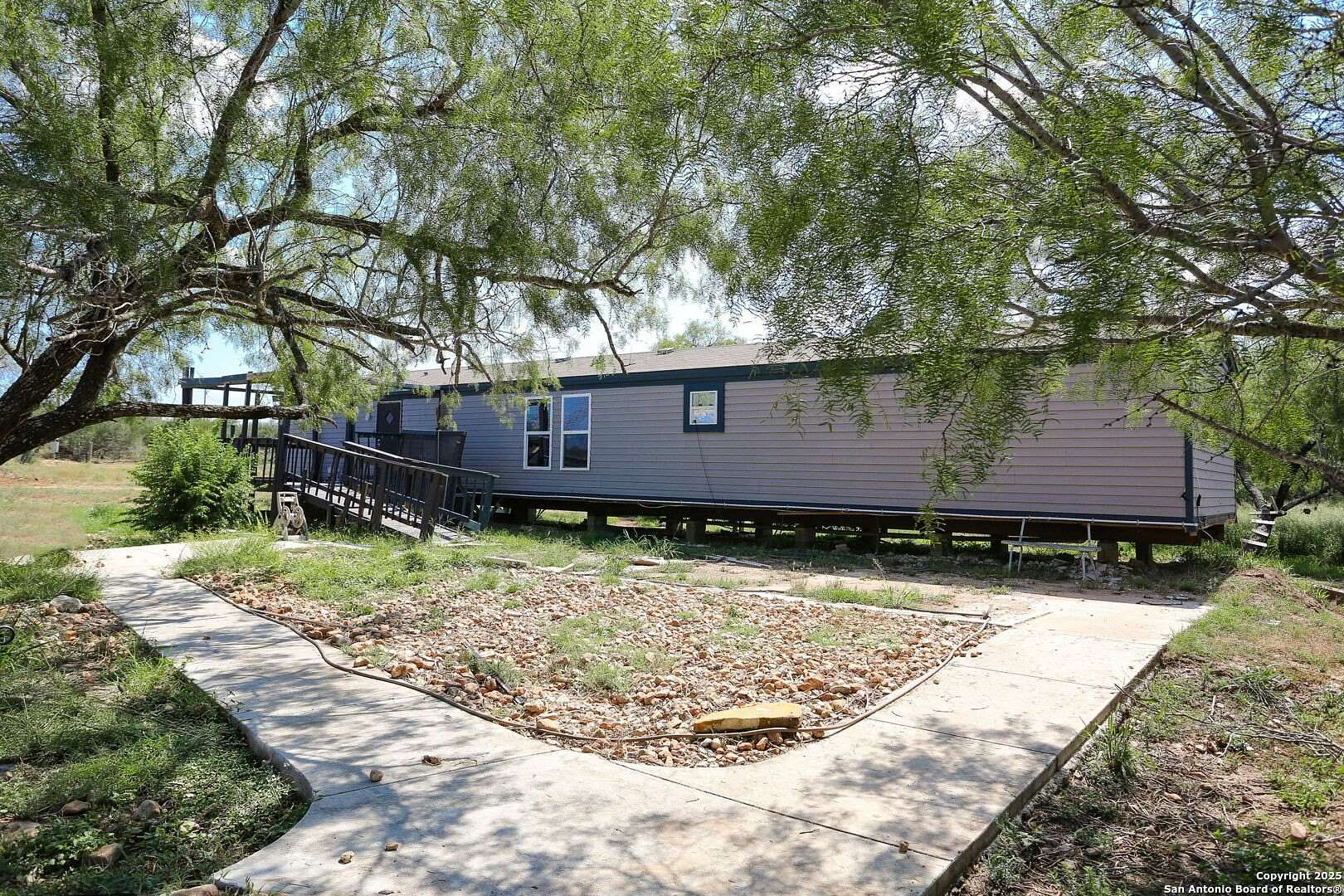 5 Acres of Residential Land with Home for Sale in Devine, Texas