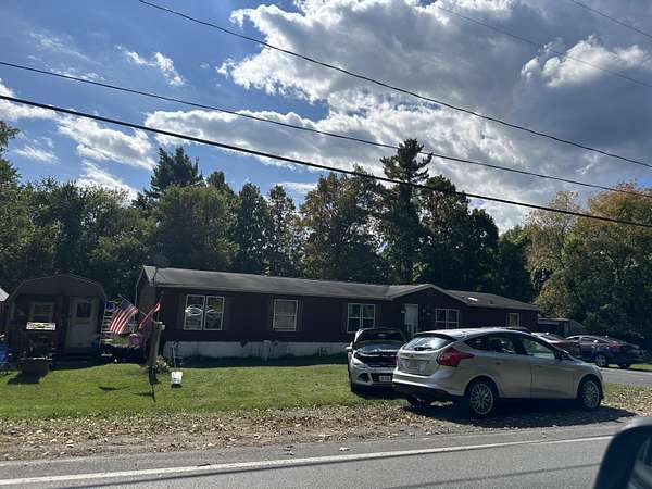 0.9 Acres of Land with Home for Auction in Plattsburgh, New York