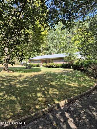 2.8 Acres of Residential Land with Home for Sale in Scotts Hill, Tennessee