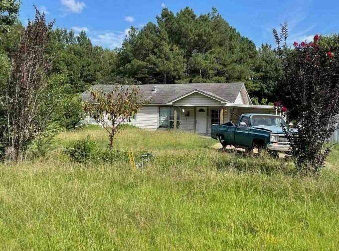 7.6 Acres of Land with Home for Auction in Bastrop, Louisiana