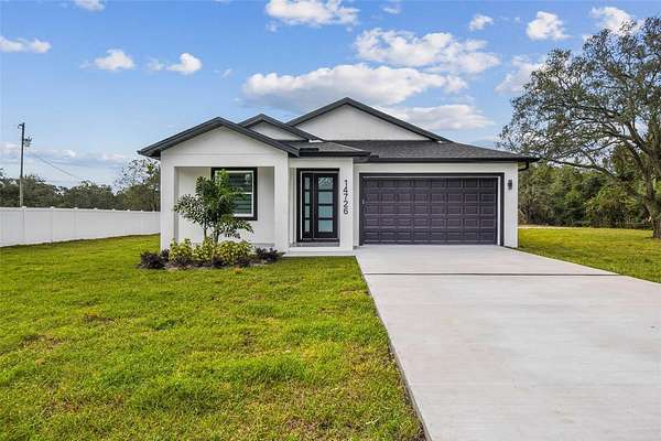 2.3 Acres of Residential Land with Home for Sale in Spring Hill, Florida