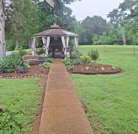 9.84 Acres of Land with Home for Sale in Clifton, Tennessee