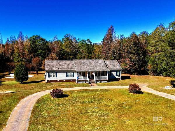 13.6 Acres of Land with Home for Sale in Coffeeville, Alabama