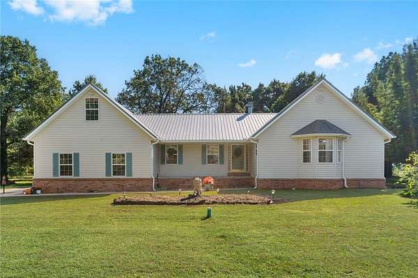 11.6 Acres of Land with Home for Sale in Gravette, Arkansas