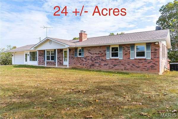 24.8 Acres of Land with Home for Auction in De Soto, Missouri