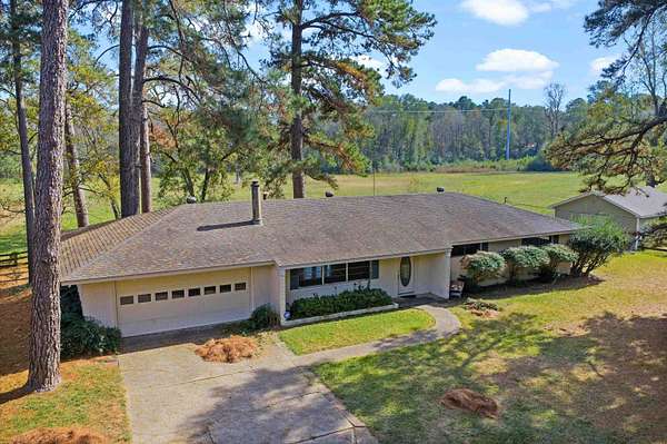 11.5 Acres of Land with Home for Sale in Carthage, Texas