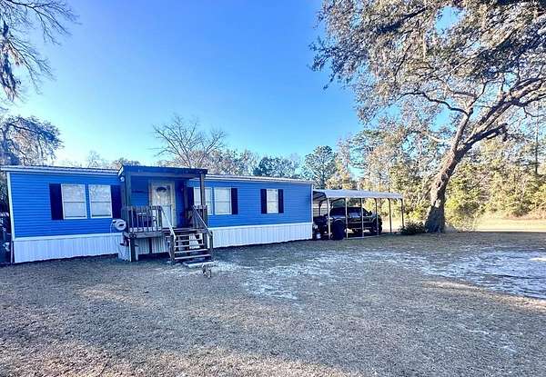 5 Acres of Residential Land with Home for Sale in Chiefland, Florida