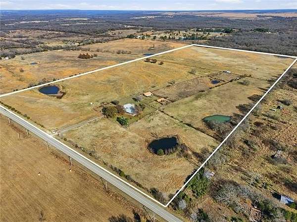 80 Acres of Agricultural Land with Home for Sale in Okemah, Oklahoma