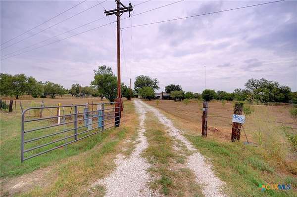 5 Acres of Residential Land with Home for Sale in Devine, Texas