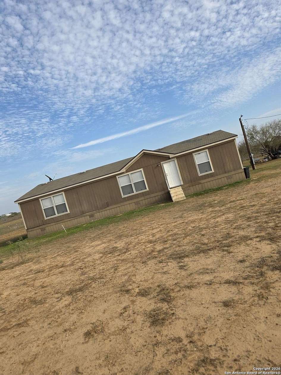 10 Acres of Residential Land with Home for Sale in Poteet, Texas