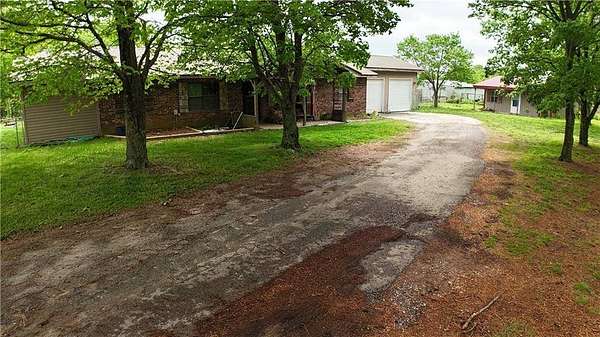 99.4 Acres of Land with Home for Sale in Gravette, Arkansas