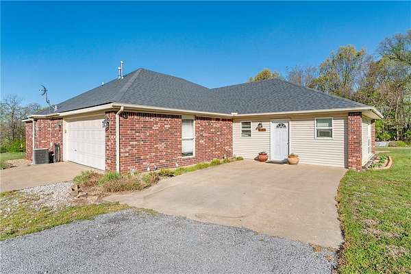 5.58 Acres of Land with Home for Sale in Lowell, Arkansas