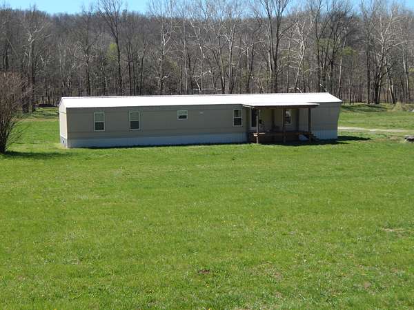 13.7 Acres of Recreational Land with Home for Sale in Clifton, Tennessee