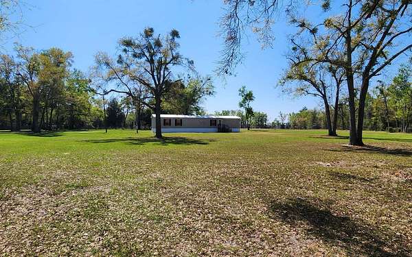 7.75 Acres of Land with Home for Auction in Live Oak, Florida
