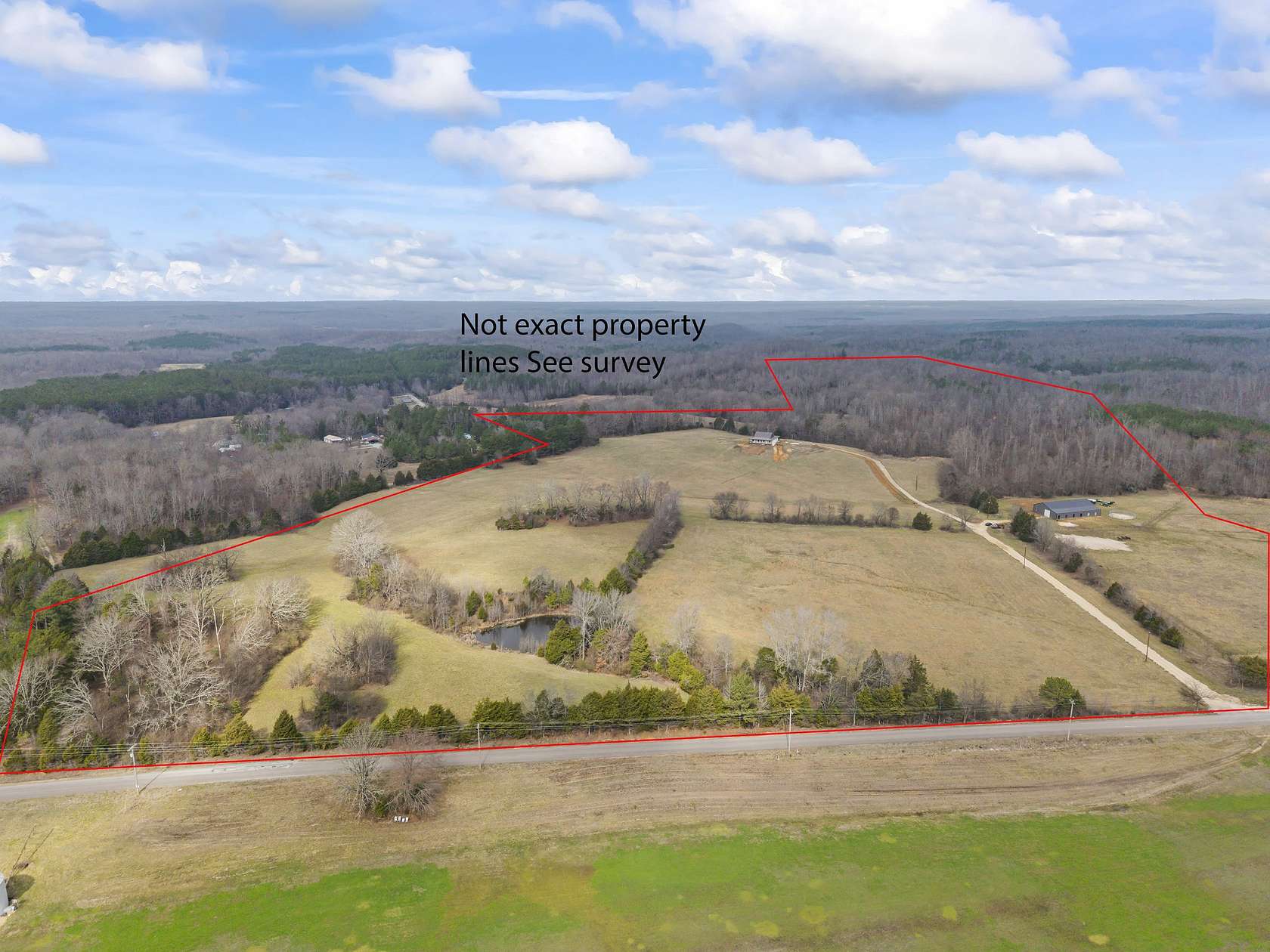 124 Acres of Land with Home for Sale in Holladay, Tennessee