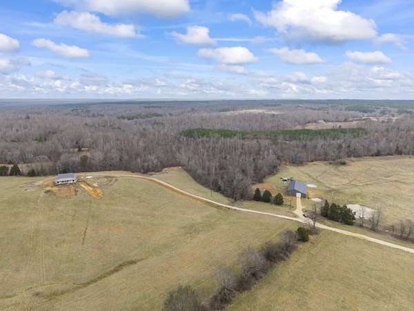 124 Acres of Land with Home for Sale in Holladay, Tennessee