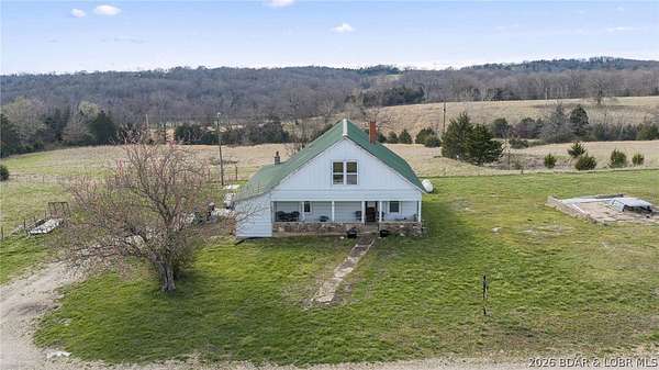 60 Acres of Agricultural Land with Home for Sale in Brumley, Missouri