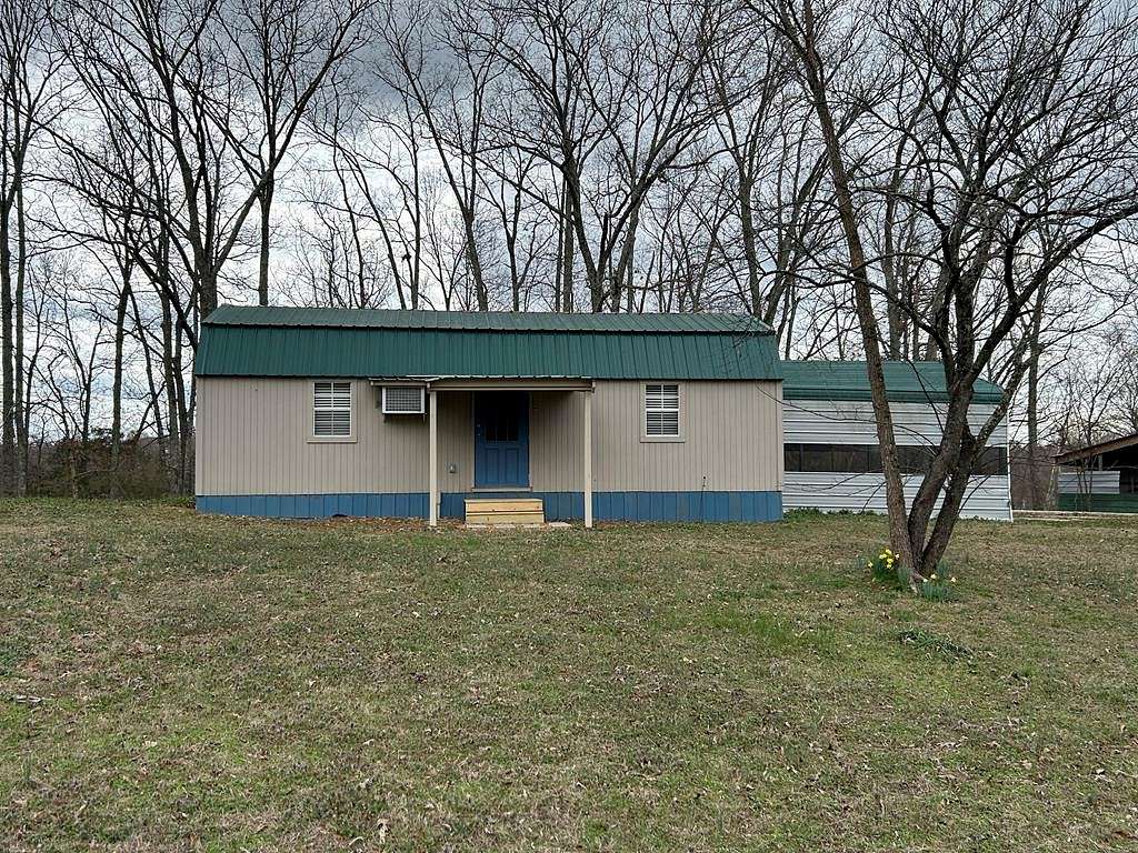 0.9 Acres of Land with Home for Sale in Big Sandy, Tennessee