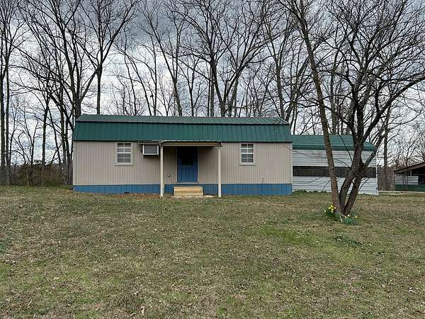 0.9 Acres of Land with Home for Sale in Big Sandy, Tennessee