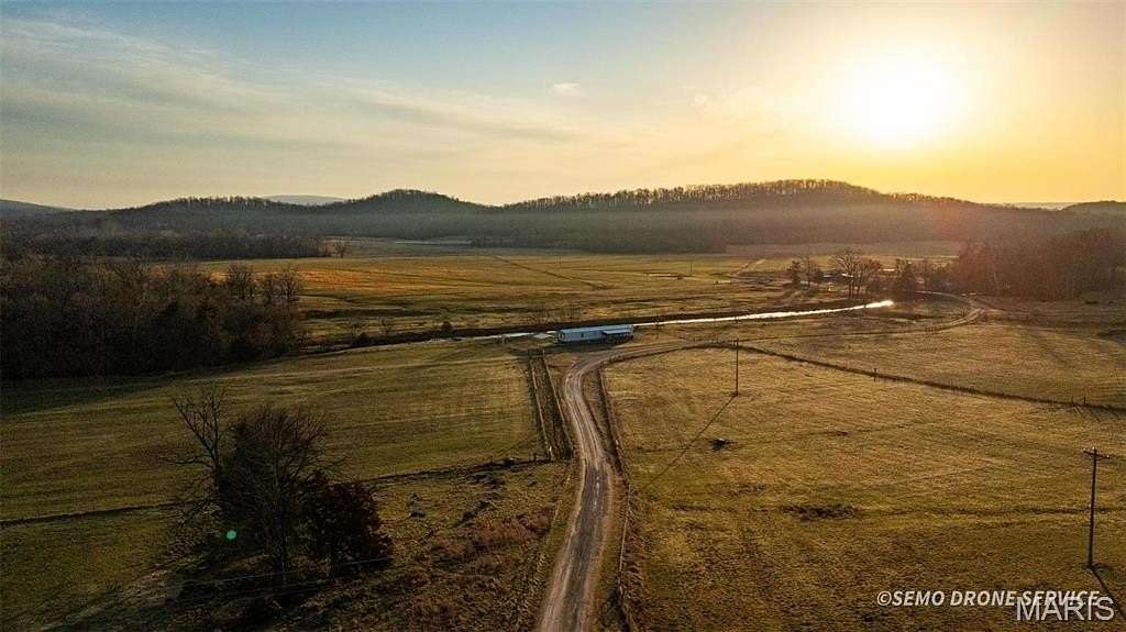 211 Acres of Agricultural Land with Home for Sale in Patterson, Missouri