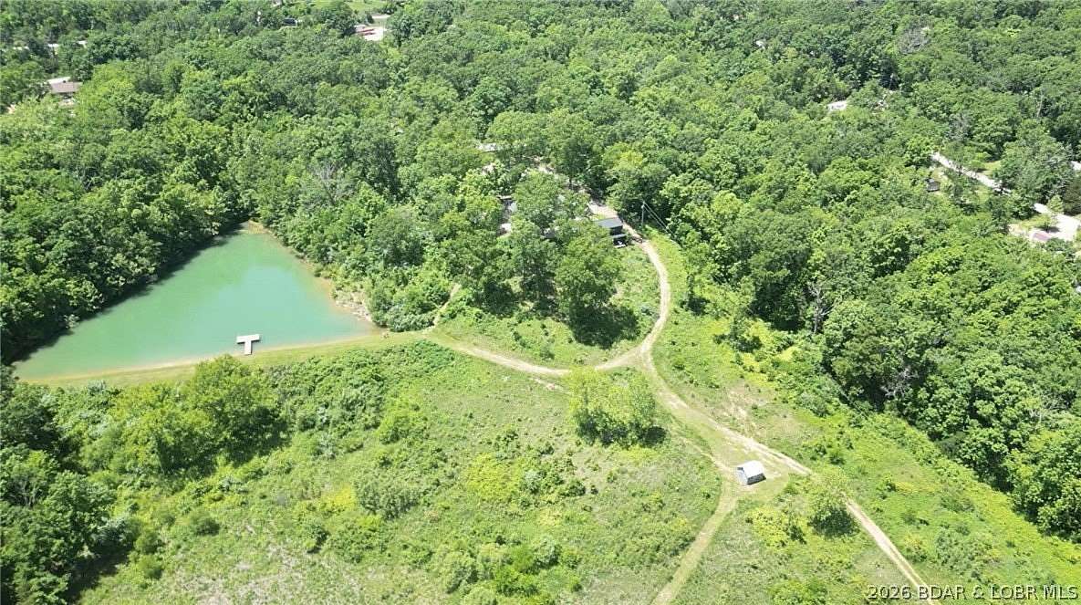60 Acres of Agricultural Land with Home for Sale in Eldon, Missouri
