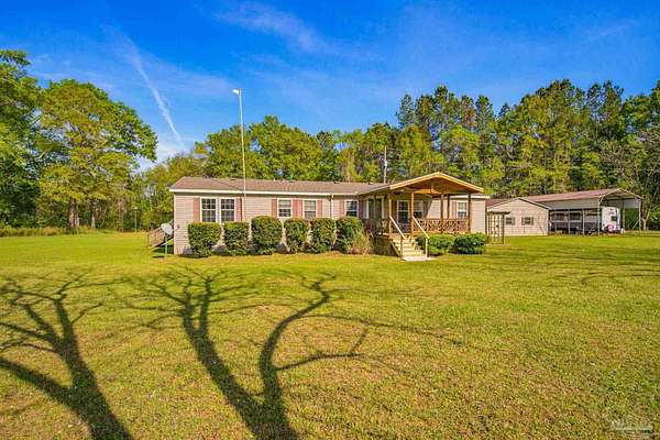 10.3 Acres of Recreational Land with Home for Sale in Munson, Florida